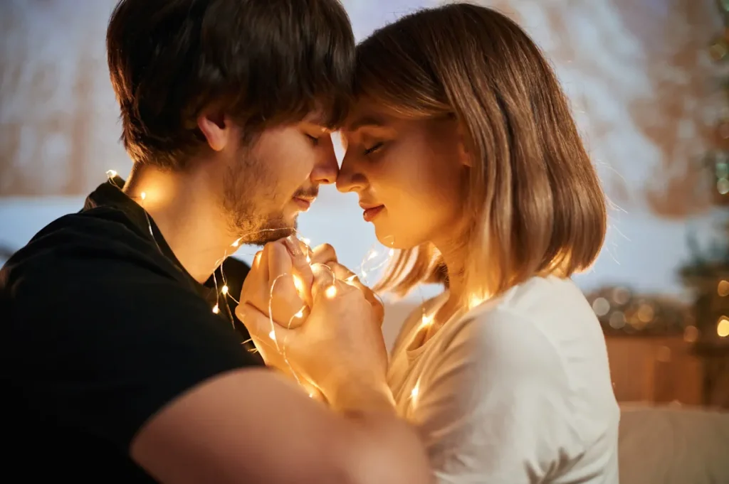 Un couple qui se prend dans les bras avec des lumières qui les entourent